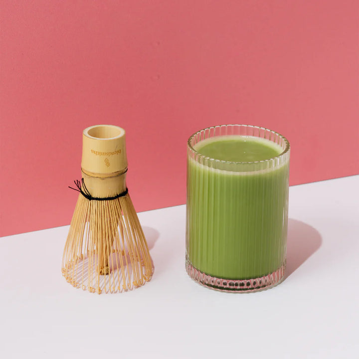 Ceremonial grade Japanese matcha powder in traditional chawan bowl with bamboo whisk (chasen)